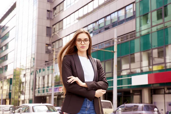 年轻的女商人戴着眼镜和外套 站在街上交叉的手臂 — 图库照片