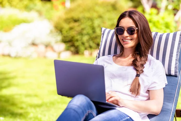 Shot Happy Young Woman Sitting Sunbed Garden Using Her Laptop — Stock Photo, Image