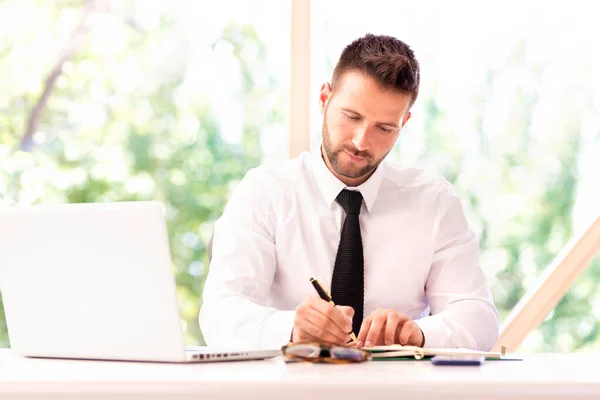 Shot Confident Businessman Writing Something While Sitting Office Desk His — Stock Photo, Image