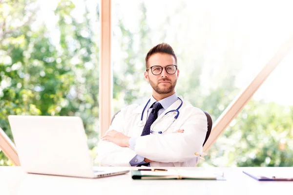 Portrait Male Doctor Sitting Arms Crossed His Laptop — Stock Photo, Image