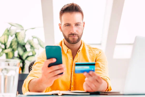 Shot Man Holding Credit Card Mobile Phone His Hands While — Stock Photo, Image