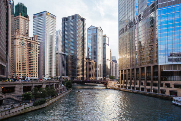 Chicago, USA - August 14, 2015: Chicago River and surrounding buildings including Trump Tower as the sun sets on a hot summers day