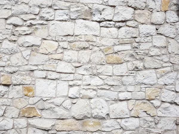 Old bright white pattern stone wall texture. — Stock Photo, Image