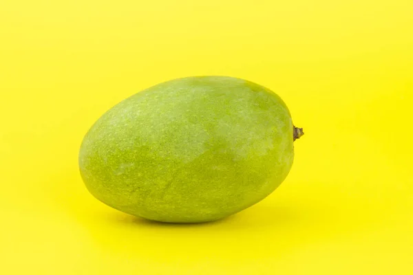 A mango isolated on yellow background. — Stock Photo, Image