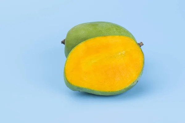 Yellow slice mango isolated on blue — Stock Photo, Image