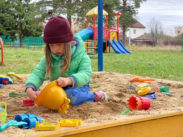 Little lovely girl baby playing in the sandbox on the playground. — Stock Photo, Image