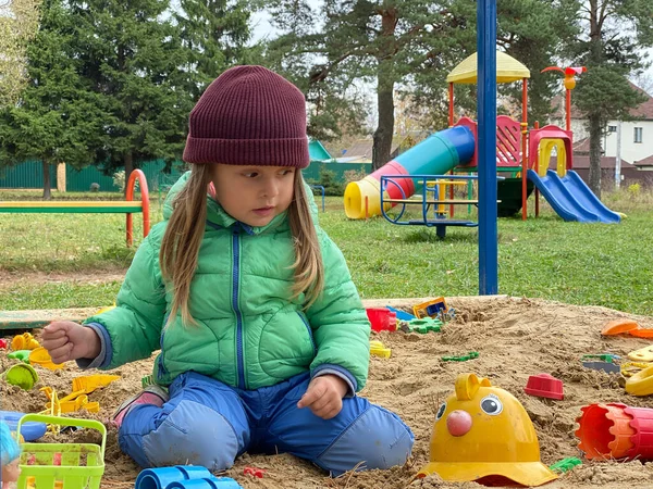 Little lovely girl baby playing in the sandbox on the playground. — Stock Photo, Image