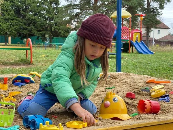 Little lovely girl baby playing in the sandbox on the playground. — Stock Photo, Image