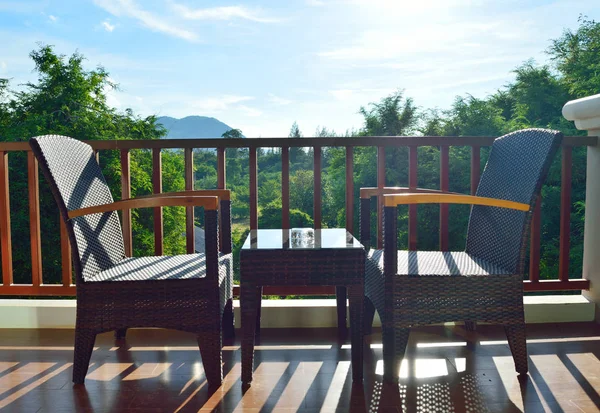 chairs overlooking rolling mountain hills on a blue sky day