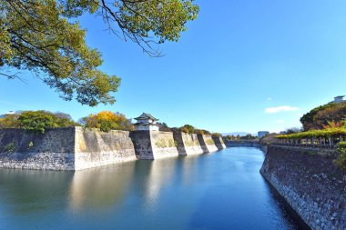 Osaka Kalesi Japonya su ile çevrili mavi gökyüzü ile