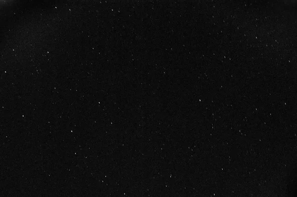 A black and white pic of the Dark Sky full of stars during the total lunar eclipse