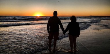 bir günbatımı arka plan ile gölge yaşlı çift