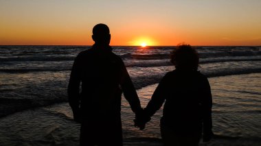 bir günbatımı arka plan ile gölge yaşlı çift