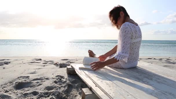 Young Woman Sitting Sea Looks Horizon Dawn Wind Dressed White — Stock Video