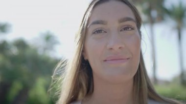 Genç, beyaz, sarışın bir kadın kameraya bakıyor, kendine güveni tam bir maske takıyor, güzel bir kadının yüzünü kapatıyor ve güvenli Coronavirus koruma maskesini takıyor.
