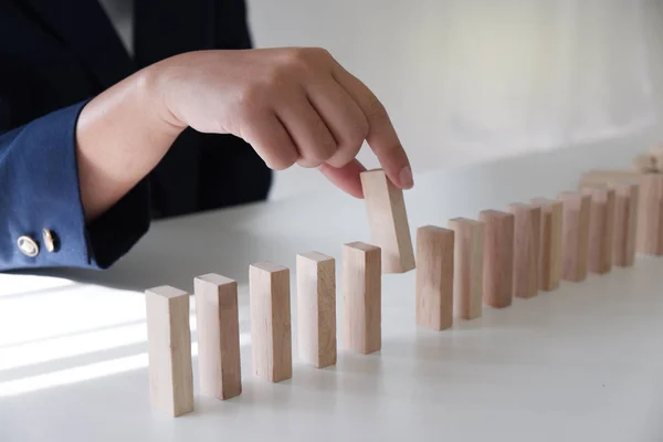 Closeup of business women playing wood blocks stack game, concept of business growth, planning, gambling, risk.