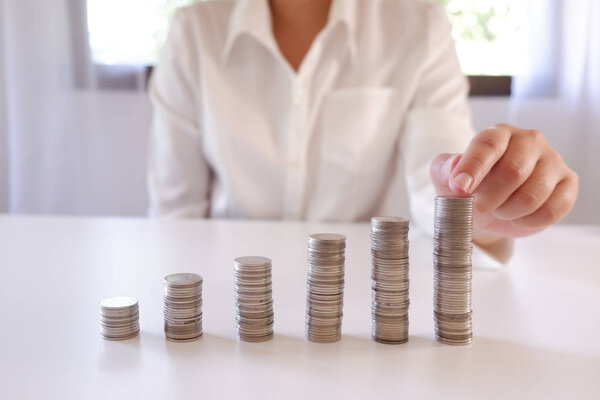 Business Person Placing Coin Over The Increasing Coins Stack.