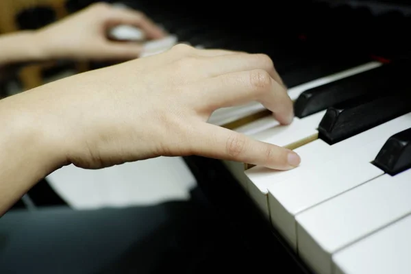 Mano femenina de primer plano tocando piano de cola . —  Fotos de Stock