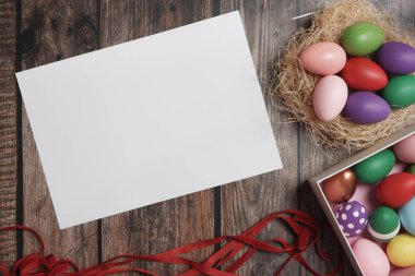 Ahşap masa kopyalama alanı düz yatıyordu renkli Paskalya yumurtaları.