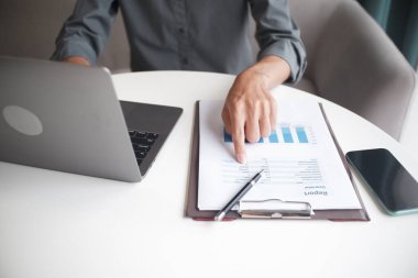 Closeup hand of unrecognizable businessman, accountant, banker at the workplace