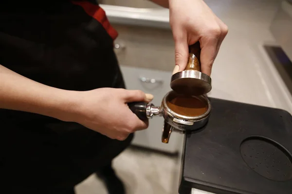 Barista makes coffee in a coffee bar