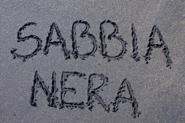 Sabbia Nera (black sand) inscription drawn on black sand