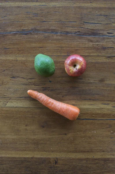 A confused face made out of various fruits and vegetables