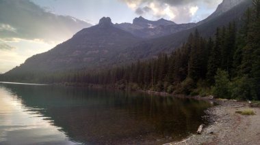 Üst Kintla Gölü buzul Milli Parkı Montana. Orman ağaçları ve dağ doruklarına tarafından çevrili Gölü güzel yansıması. Ütopik cennet şehirler ve kalabalık çok huzurlu