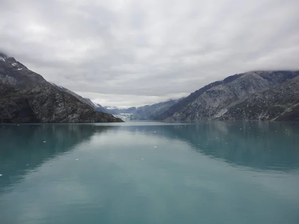 stock image Passage in the Pacific Ocean between two mountain ranges. Calm peaceful waters flowing slowly under a cloudy sky.