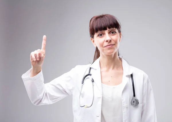 Smiling Woman Doctor Nurse Stethoscope Her Neck Holding Finger Pointing — Stock Photo, Image