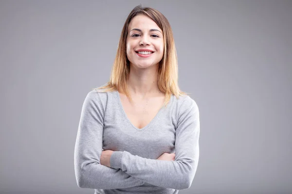 One Happy Young Woman Crossed Arms Wearing Grey Shirt Light — Stock Photo, Image