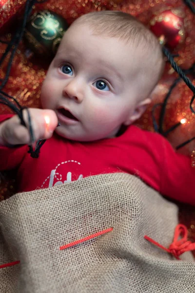 Aranyos Kis Bébi Játszik Karácsonyi Fények Miközben Fekve Gyermekágy Körül — Stock Fotó