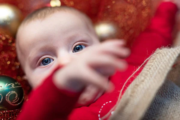 Blue Eyed Baby Boy Red Pajamas Laying Christmas Decorations Shot — Stock Photo, Image