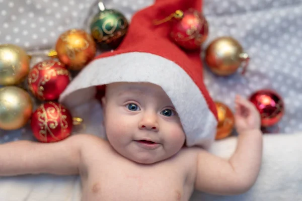 Fun Little Newborn Baby Wearing Santa Claus Hat Lying Smiling Stock Photo