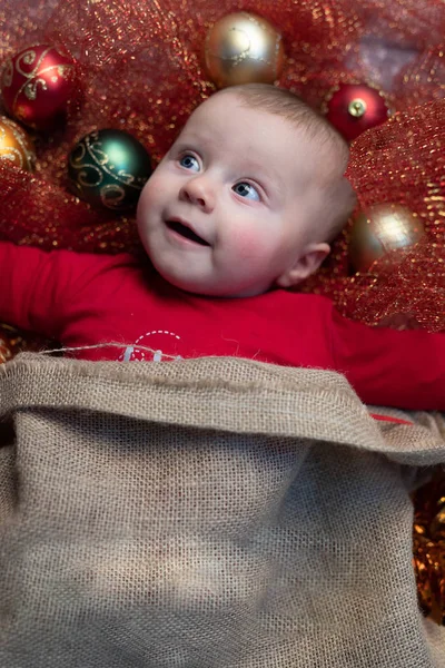 Cute Happy Baby Surrounded Christmas Decorations Red Tinsel Lying Cot Stock Photo