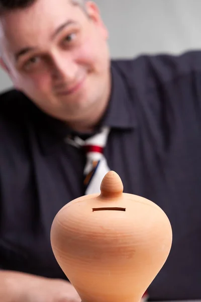 Smiling successful businessman with a money box — Stock Photo, Image