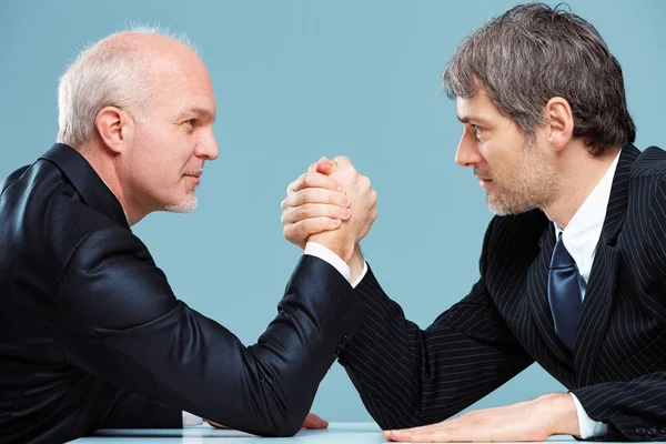 Two businessmen facing off arm wrestling — Stock Photo, Image