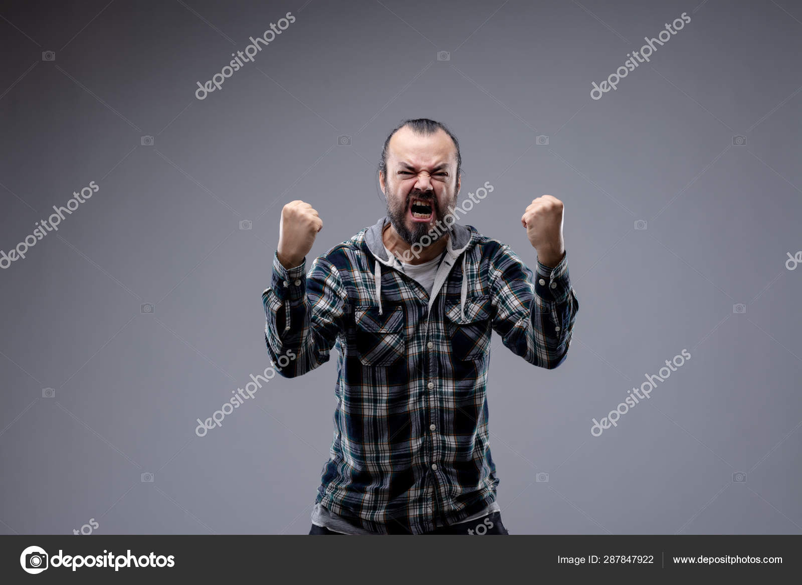 Man menacingly screaming at the phone Stock Photo