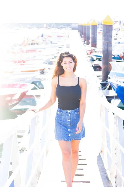 Young woman walking on the boat dock