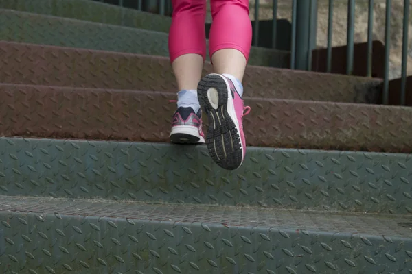 Woman athlete climbing stairs