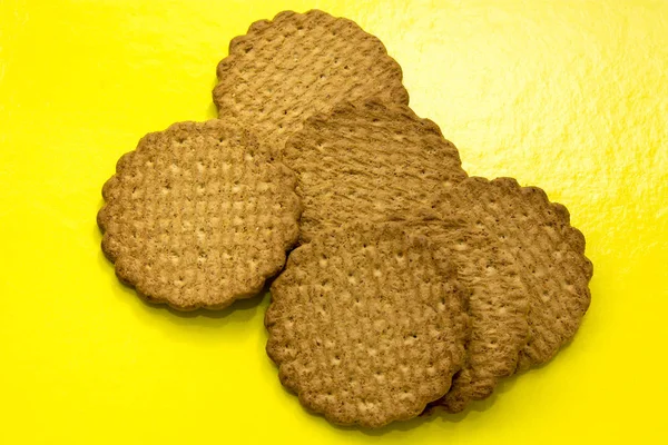 Wholemeal cookies on yellow background