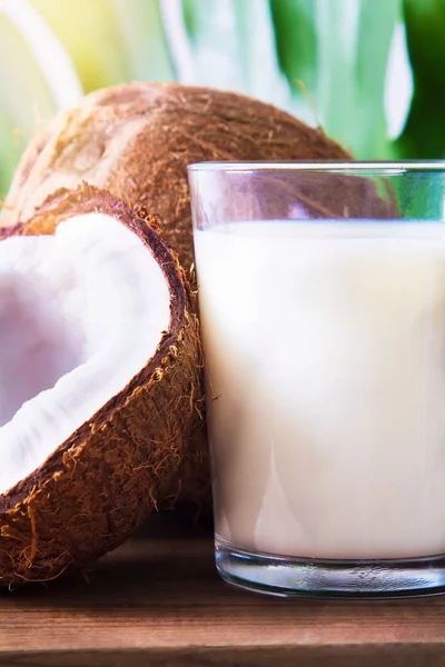 coconuts and glass of coconut milk on the table
