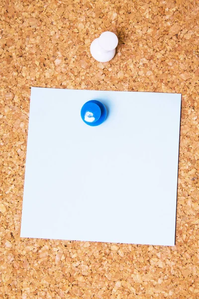 Colored paper with colored pins on the corkboard