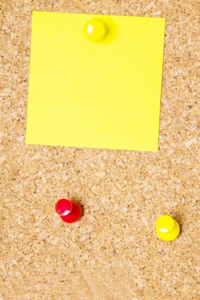 Colored paper with colored pins on the corkboard