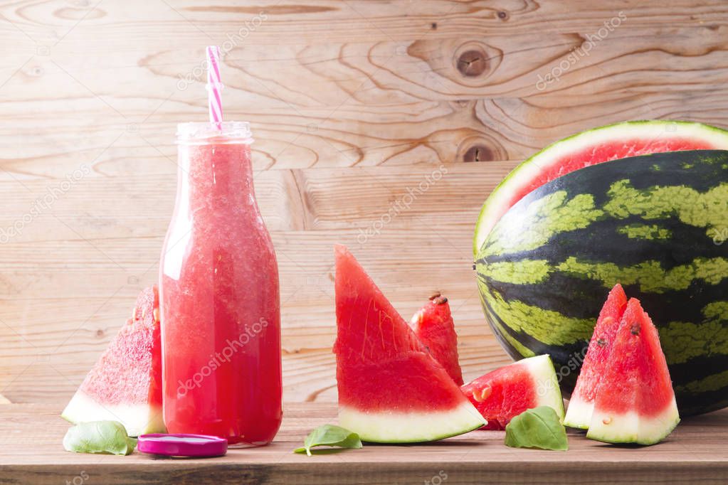 Fresh watermelon smoothie in the mason jar on wooden background. Summer, healthy organic food concept.