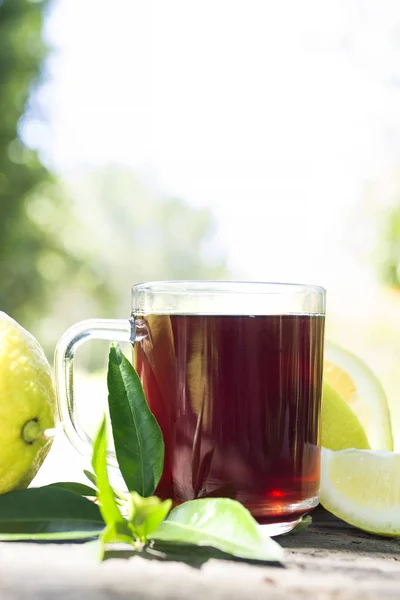 hibiscus tea with lemon and green leaves