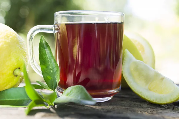 hibiscus tea with lemon and green leaves