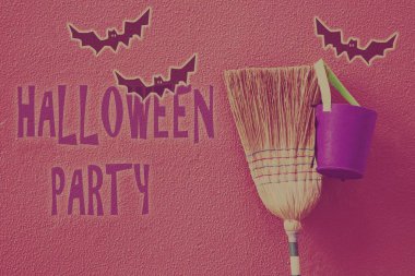 Cadının süpürgesi ve kazanı. Duvara yaslanmış yarasalar, cadılar bayramı konsepti.