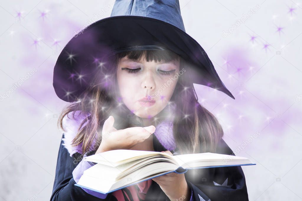witch girl reading the spells in the witch book