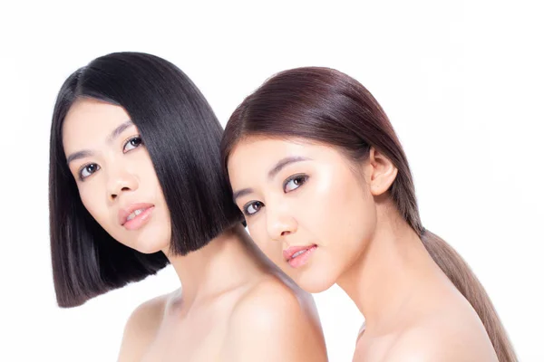 Two beautiful asian women portrait. Beautiful women looking to camera. People with youth and skin care concept isolated on white background.